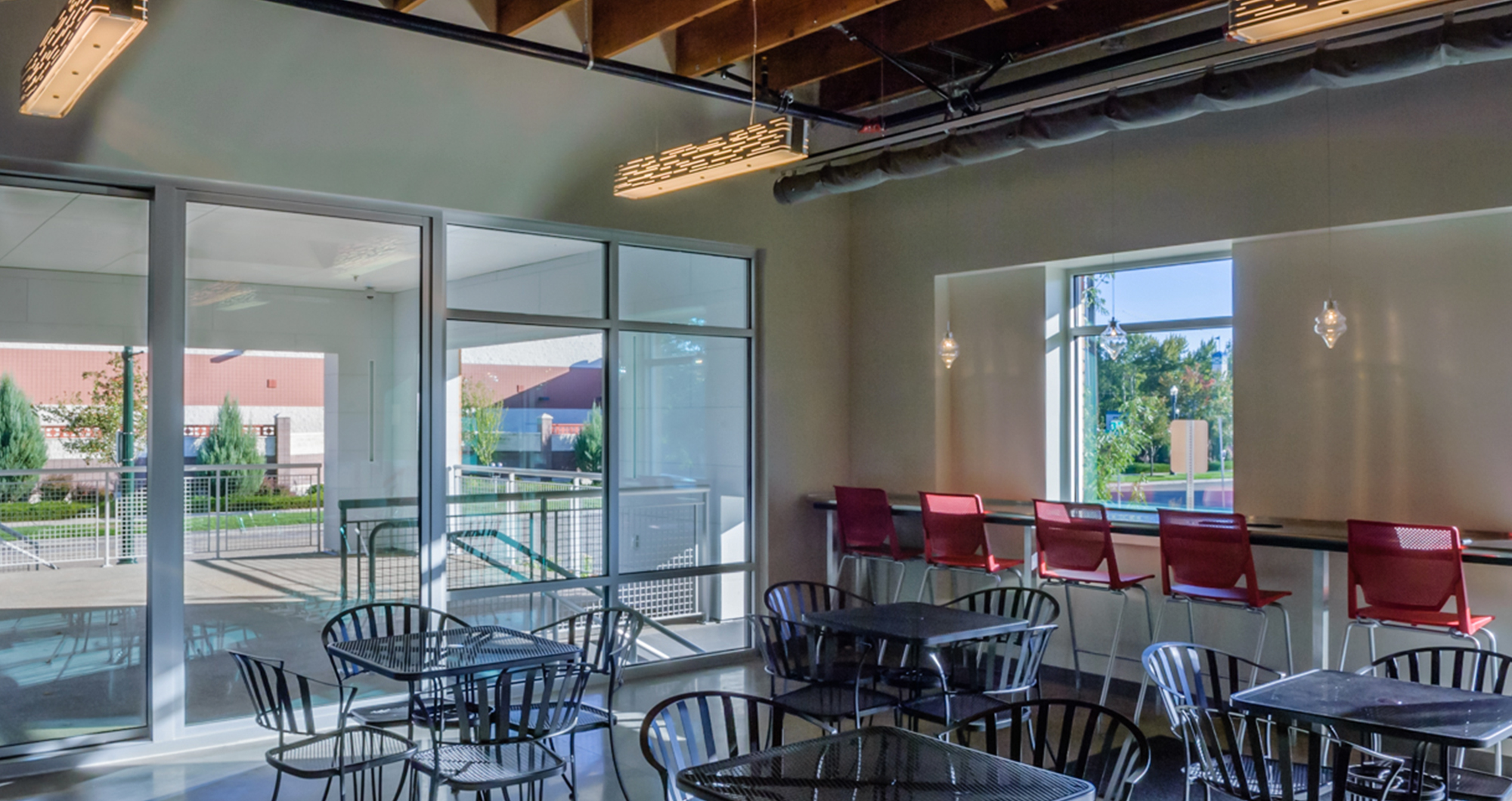 The staff Deli at CSHQA’s Boise office, with bistro seating and glass doors opening onto the entry patio.