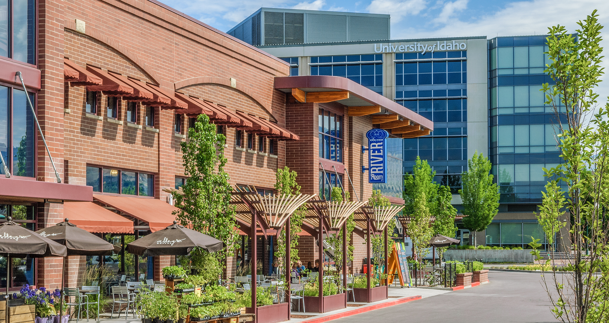 Planters, trellises, and outdoor seating line the street edge of Whole Foods Market at River Park Place in Boise.
